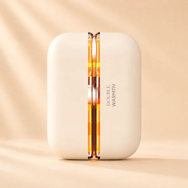 Solis Ember twin hand warmers in the Beige colourway, closed, with the seam glowing amber