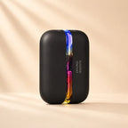 Solis Ember twin hand warmers in the Black colourway, closed, with the seam lit through the full colour range