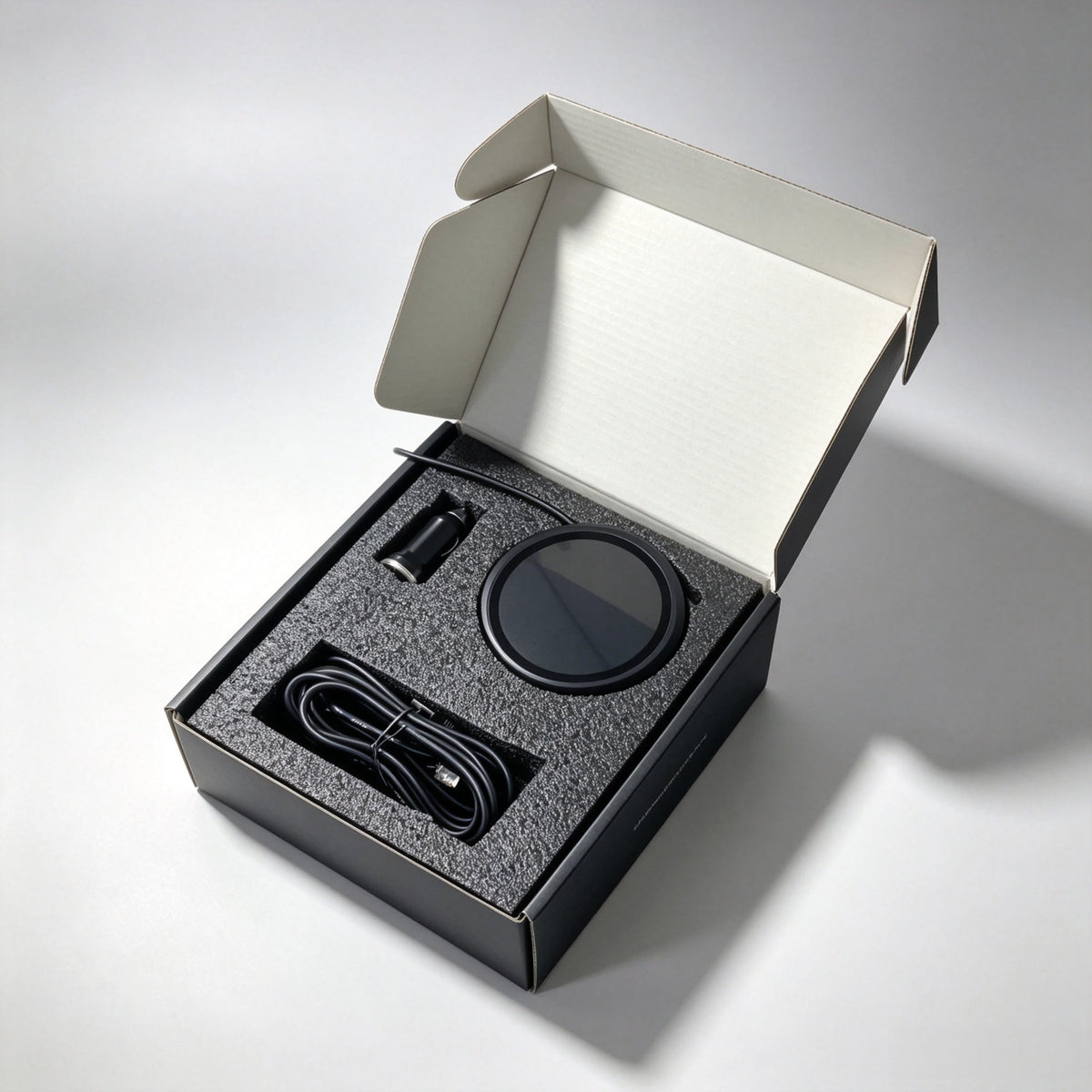 The 88 mm version in its box with the 12 V accessory-socket adapter and its cable