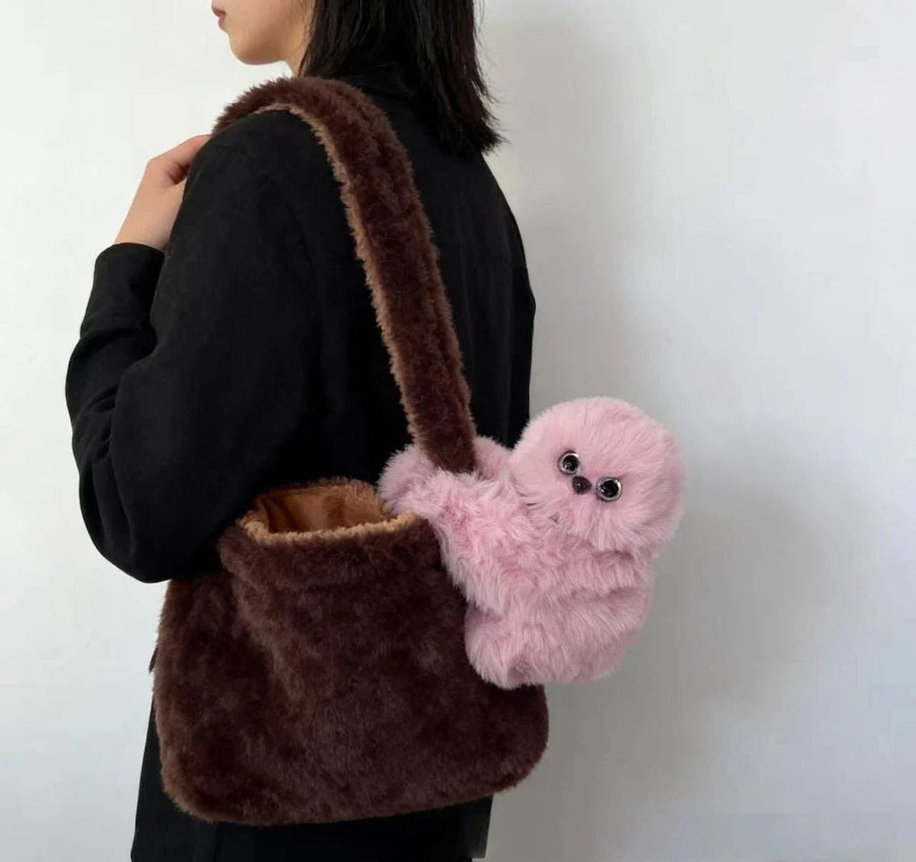 Solis Bag Charm — pink, carried at the hip