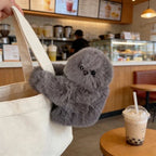 Solis Bag Charm — grey, watching the counter from a tote
