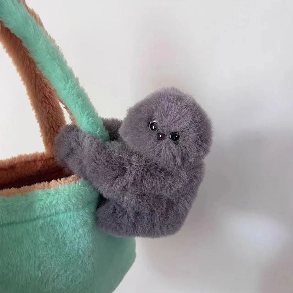 Solis Bag Charm — grey, clipped to a mint tote