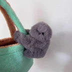 Solis Bag Charm — grey, clipped to a mint tote