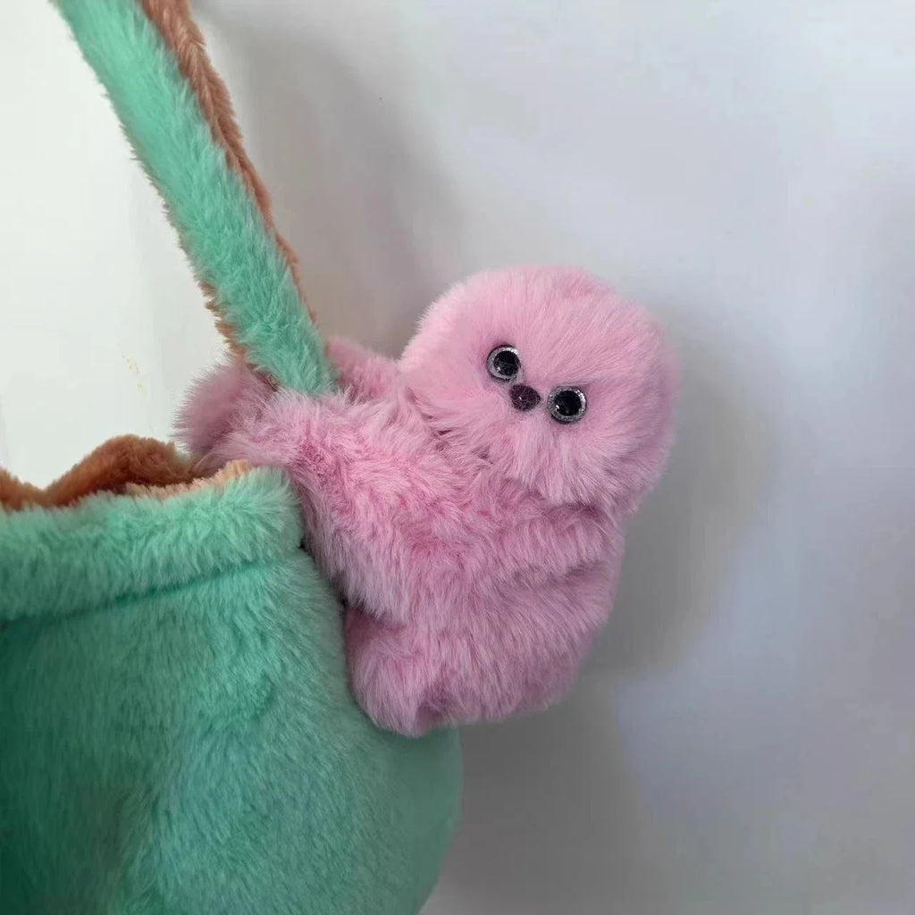 Solis Bag Charm — pink, hooked over a mint tote