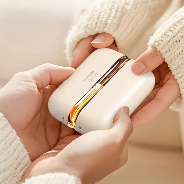 Solis Ember twin hand warmers held in two hands inside cream knitted sleeves