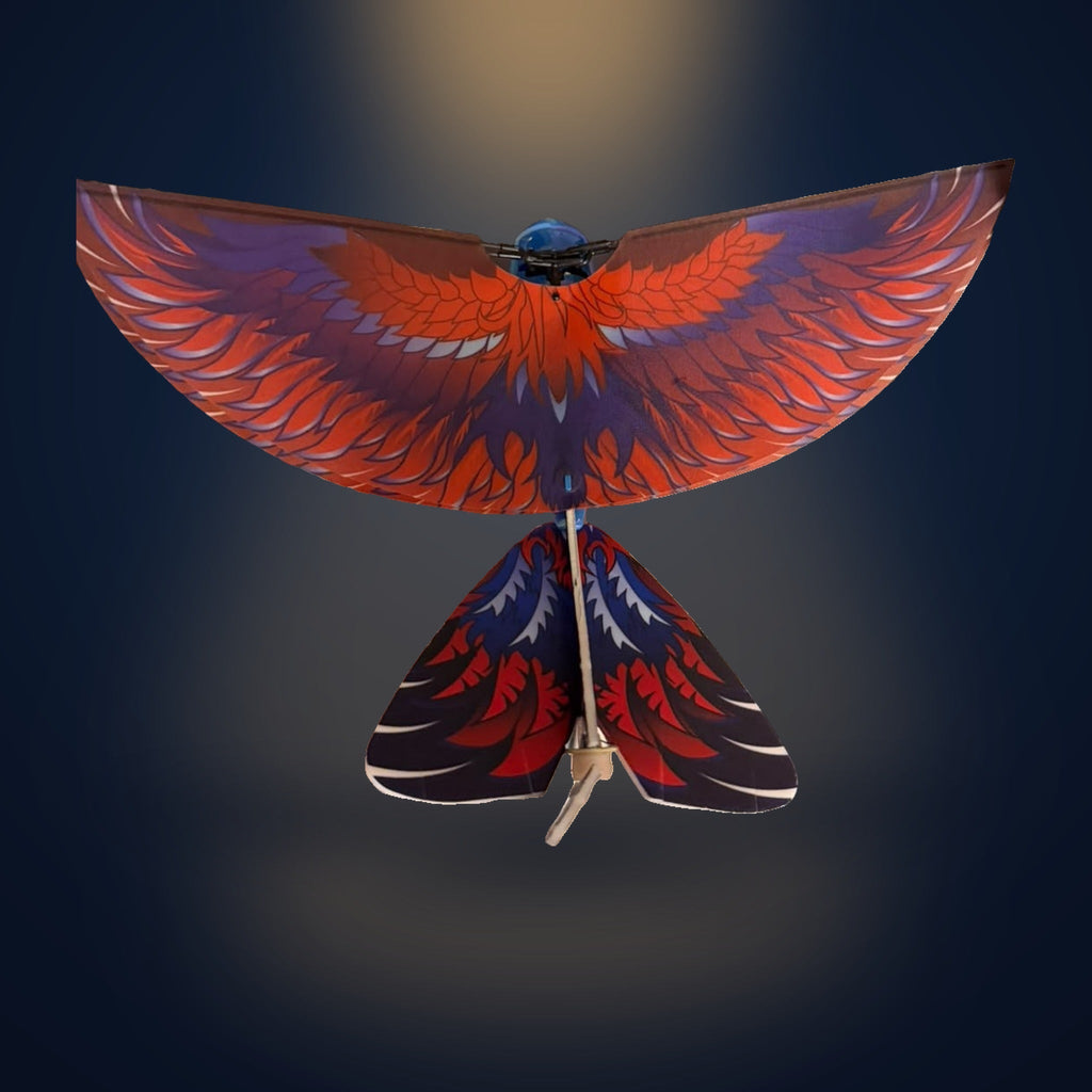 The real Solis Falco seen from above with both wings fully spread, showing the printed orange-red feather pattern and the forked tail