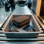 Solis Carry Case — On an airport tray beside a passport