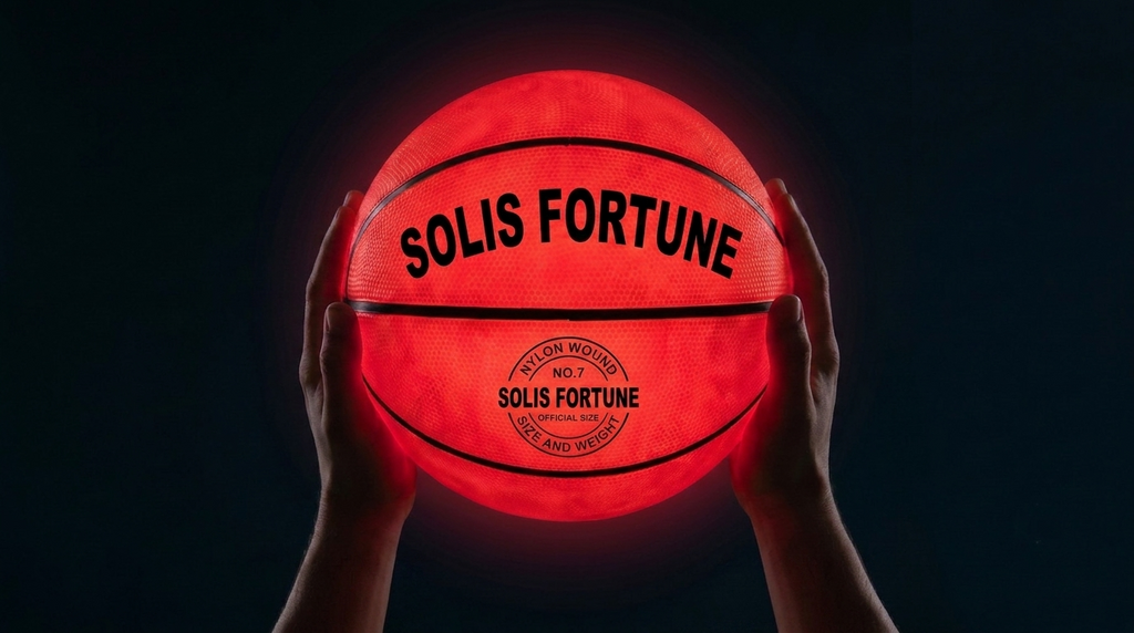 Solis Arc LED Basketball — held overhead in the dark, both LEDs lit