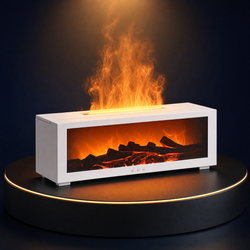 The Solis Hearth flame diffuser in white on a lit black podium, flame effect rising from the top and the ember bed glowing behind the glass