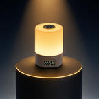 The Solis Horae touch lamp on a lit black podium, warm light and the clock lit on its base