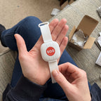 Solis Beacon — white SOS wristband with a red button held in the hand