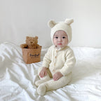 Solis Bear Cub Romper — White: fuzzy footed romper with bear-ear bonnet