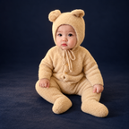 solis bear cub romper — Light Tan worn by a child on a dark navy studio background