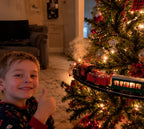 Solis Branchline — boy giving a thumbs up next to the Christmas tree train