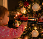 Solis Branchline — toddler pointing at the train inside the Christmas tree