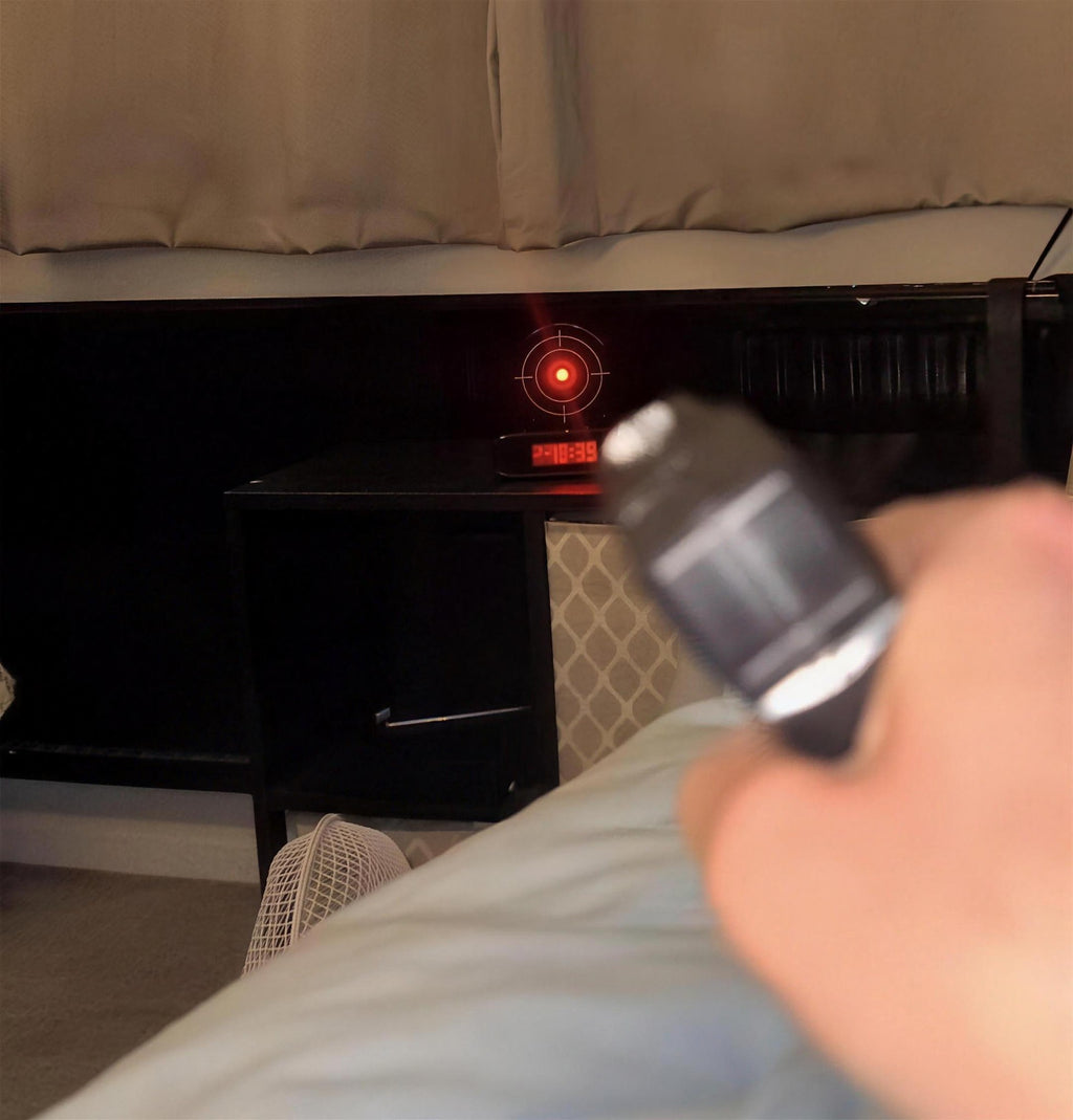 Solis Bullseye — aiming the toy blaster at the alarm clock target from bed