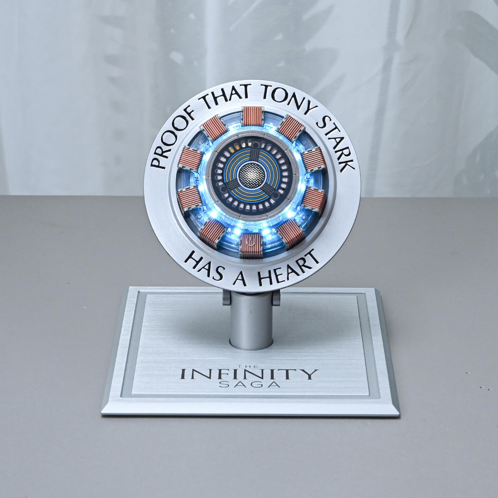 Light-up arc reactor charger glowing blue on a desk