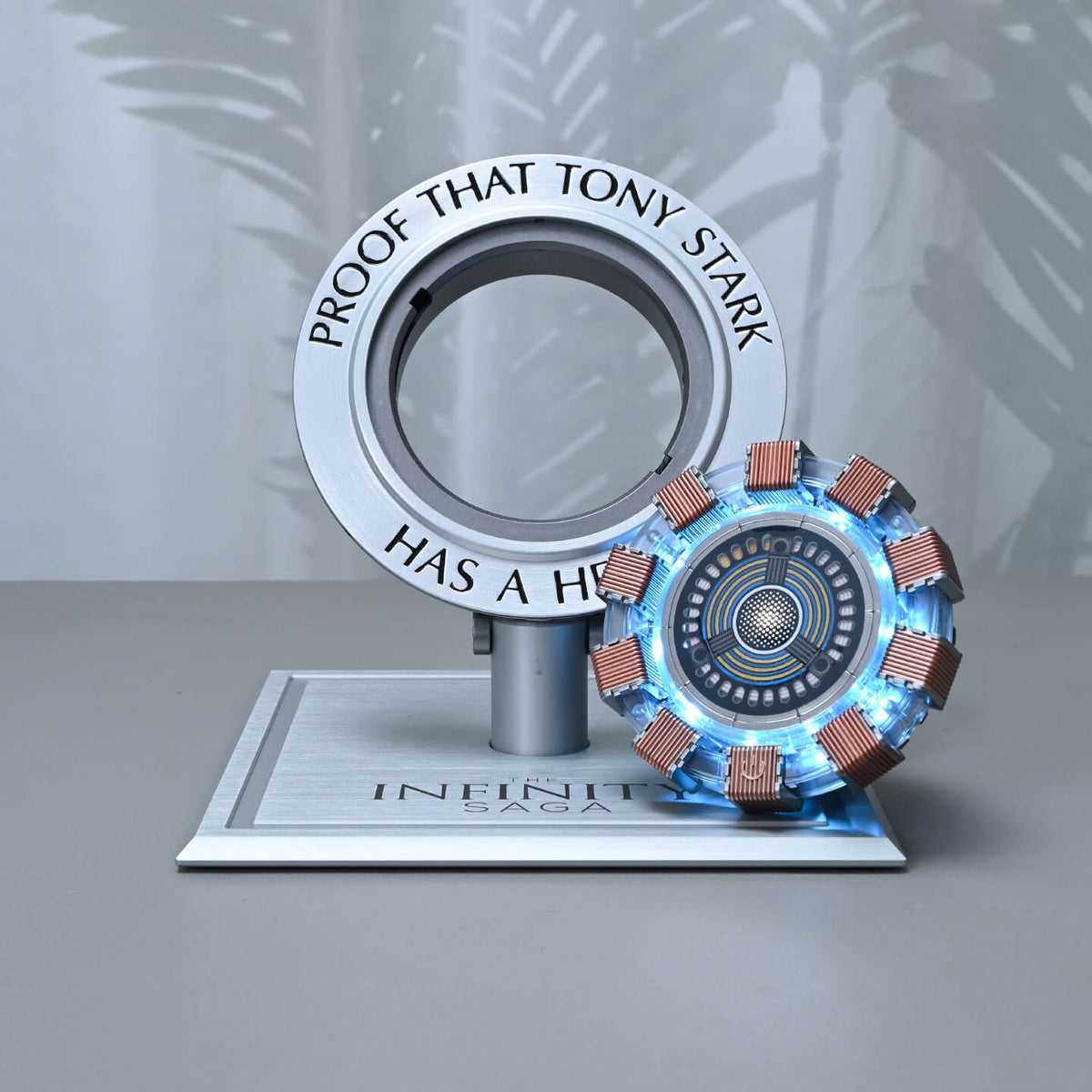 Arc reactor lifted out of its engraved ring, glowing next to the stand