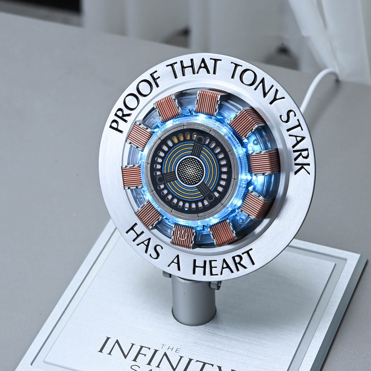 Close-up of the engraved ring, copper-toned coils and glowing core of the arc reactor charger