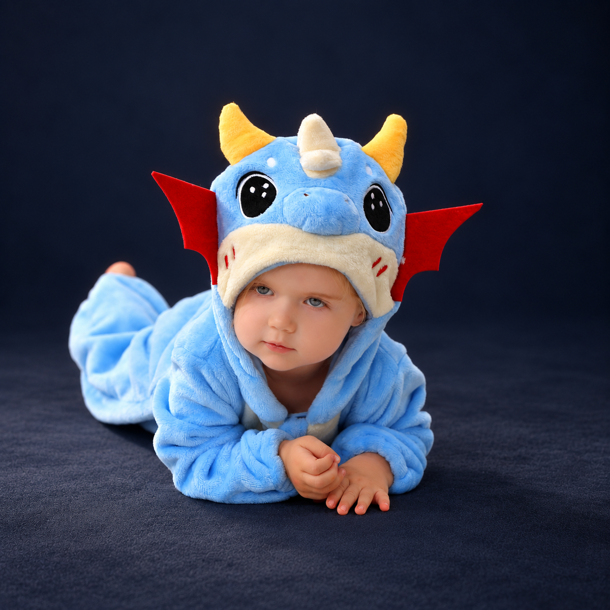 solis critter onesie blue dragon — Blue Dragon worn by a child on a dark navy studio background