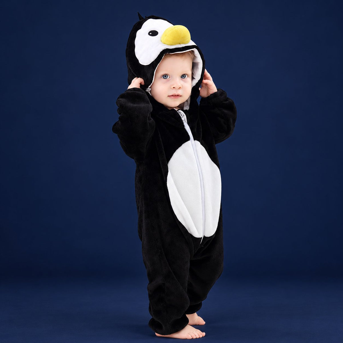 Solis Critter Onesie — Penguin: flannel hooded animal romper worn by a baby
