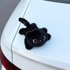Solis Cruiser Pals — black cat magnetic plush on the tailgate of a white car