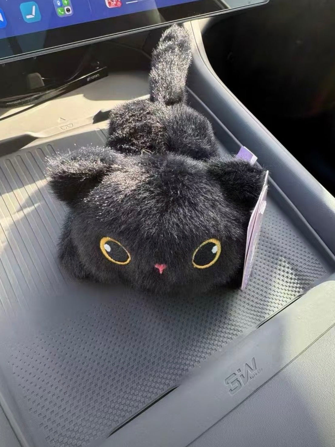 Solis Cruiser Pals — grey cat magnetic plush on a car dashboard