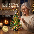 Solis Crystal Pine — woman finishing a glowing beaded crystal Christmas tree by the fireplace