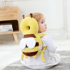 Solis Cushy — toddler wearing the bee head protector backpack while sitting on the floor