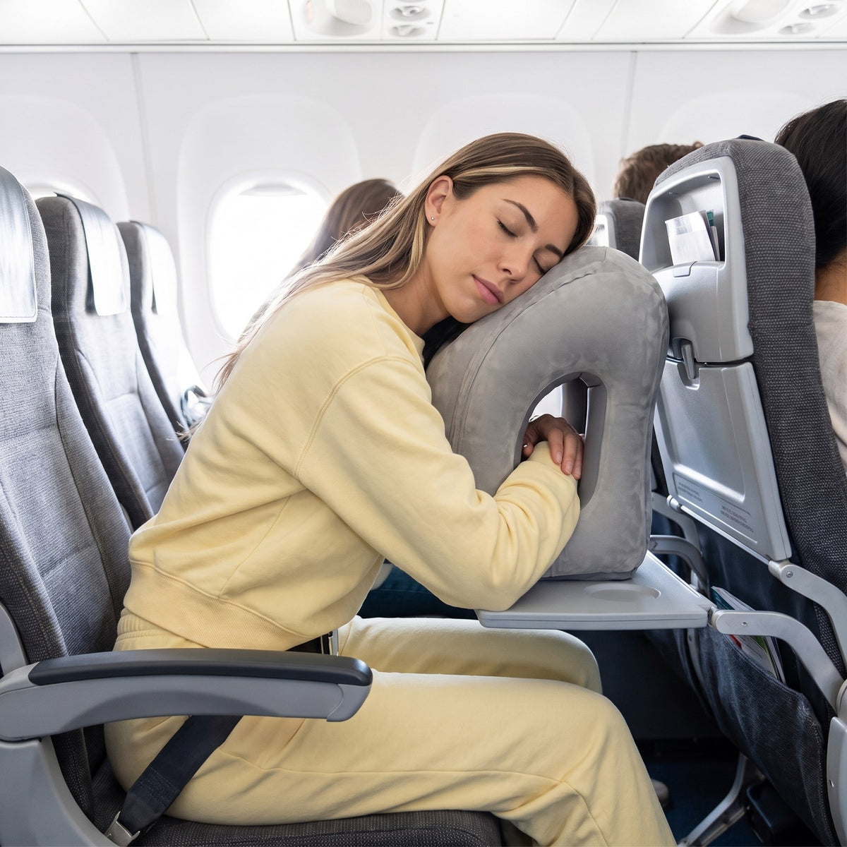 Solis Drift Travel Sleep Pillow a passenger asleep on it in a window seat