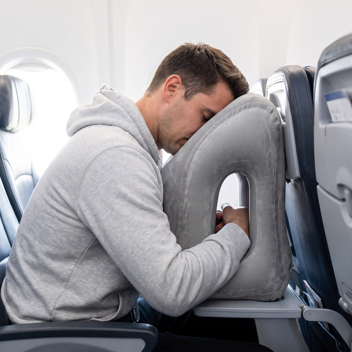 Solis Drift Travel Sleep Pillow a man resting face-down in the face opening