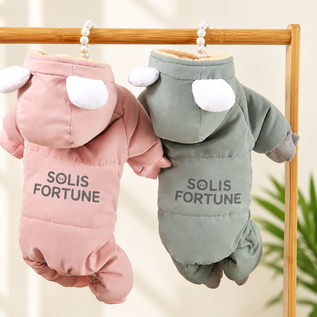 Solis Frostpaw — pink and blue-grey dog winter jumpsuits with cartoon-eye hoods on a hanger