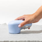 Solis Fuzzaway — sweater shaver used on a knit throw