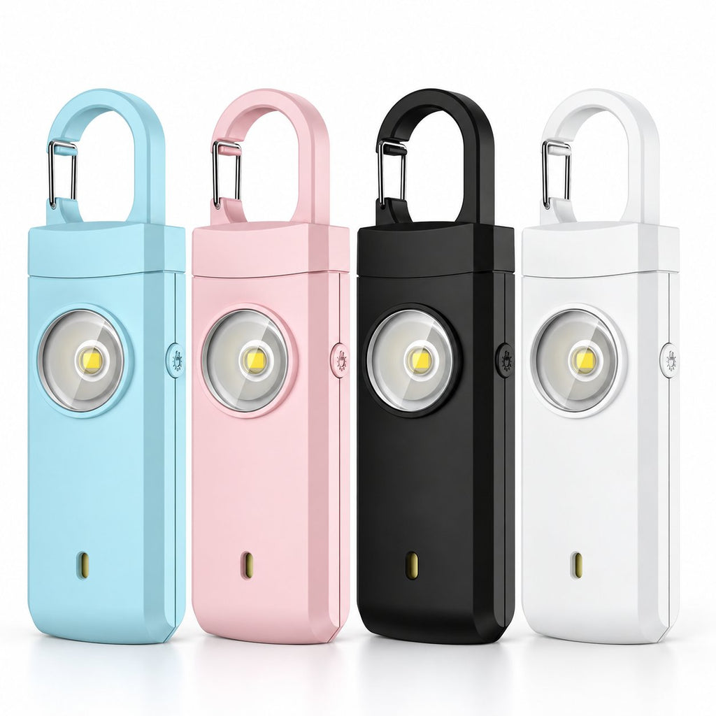 Solis Guardian — personal safety alarm keychain in blue, pink, black and white