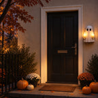 Solis Hollow Rude Ghost Night Light lit on a porch wall next to a black front door