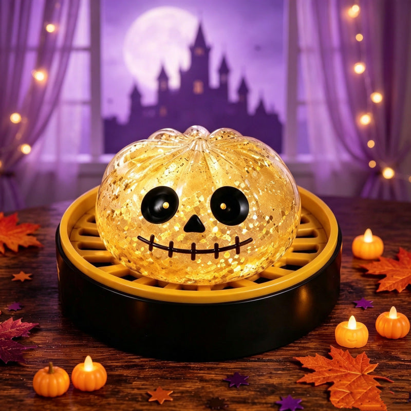 Solis Hollow — Golden Skull squishy bun, 6.5 cm, in its mini steamer
