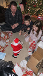 Solis — family on Christmas morning watching the dancing Santa among the presents