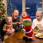 Solis Jingle Twerk — family laughing at the twerking Grinch at the Christmas table
