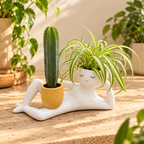 Solis Lazy Bloom — head planter with a spider plant and a cactus among garden pots