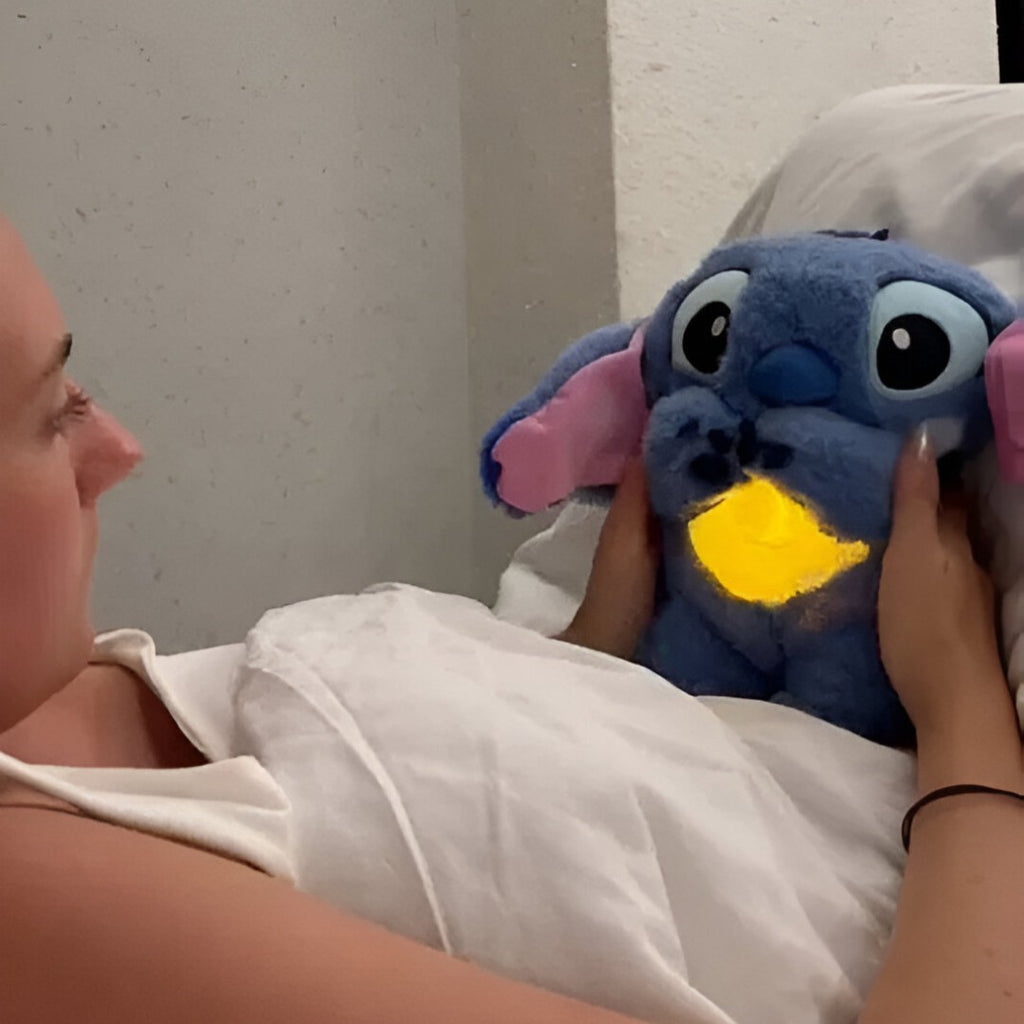 Solis Lullo — woman in bed holding the sleeping Stitch plush with a glowing belly