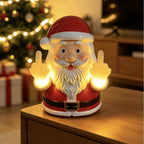 Solis Naughty Glow — middle finger Santa light glowing next to a Christmas tree