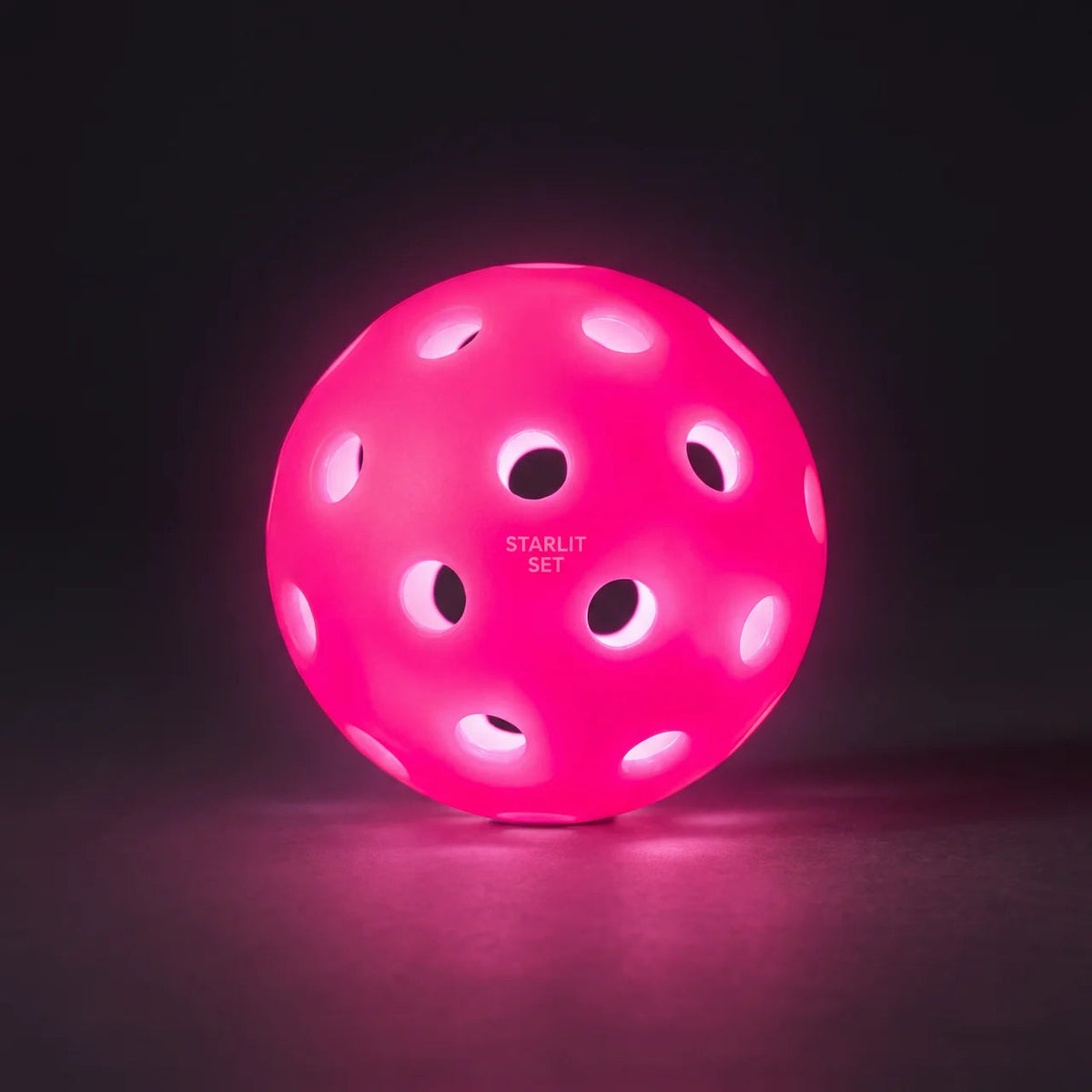 Pink glowing pickleball