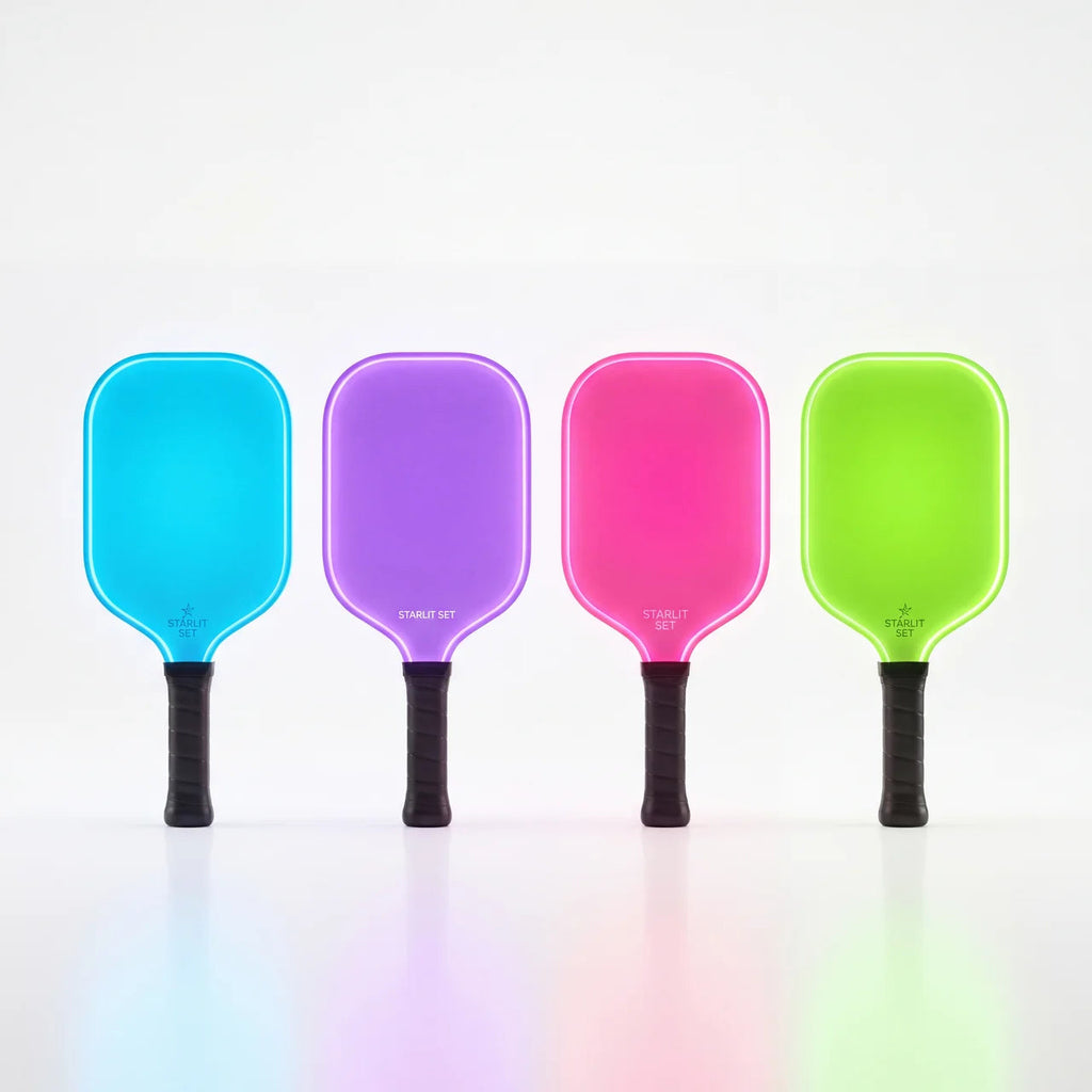 Four LED pickleball paddles lit in blue, purple, pink and green