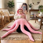 A parent holding a baby in the pink Solis Octo Costume