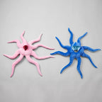 Solis Octo Costume — Pink: plush octopus costume laid flat beside the blue one