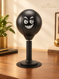 Solis Popjab — Black: desk punching ball with a grinning face on a suction base