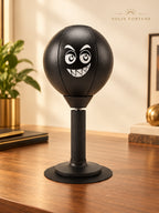 Solis Popjab — Black: desk punching ball with a grinning face on a suction base