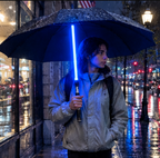 Man with backpack walking in the rain under the lightsaber umbrella, Solis Saber