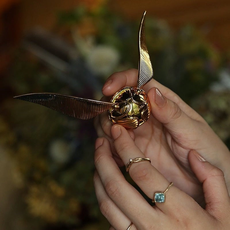 Solis Seeker — winged Golden Snitch ring box held in two hands