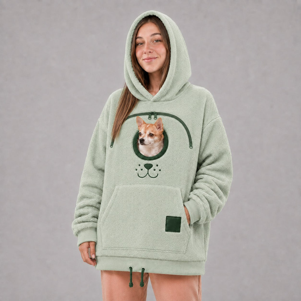 Solis Snuggle Pet Pouch Hoodie in sage green with a small dog in the pouch
